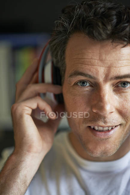 Smiling man with headphones on, close up — Stock Photo