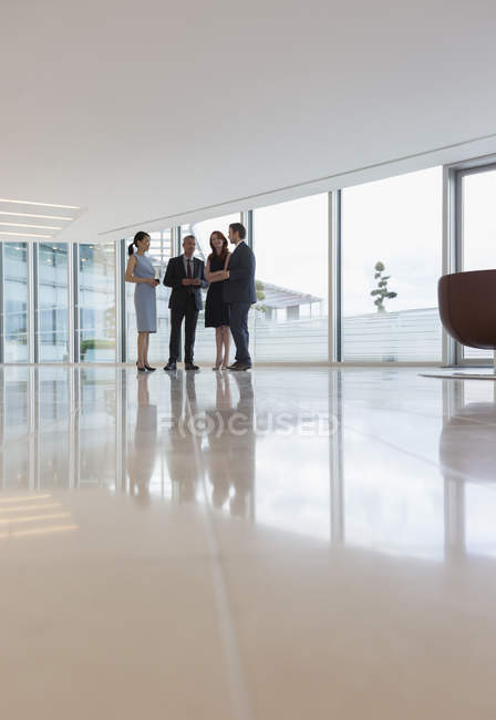Business people talking in modern office lounge — Stock Photo