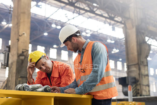 Steel workers meeting in factory together — Stock Photo