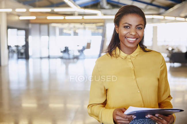 Portrait confident businesswoman at modern office — Stock Photo