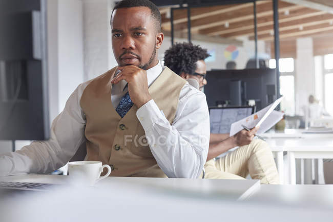 Serious, focused businessman working at computer in office — Stock Photo