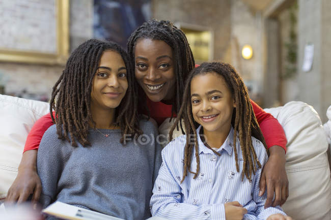Portrait smiling mother hugging daughters — Stock Photo