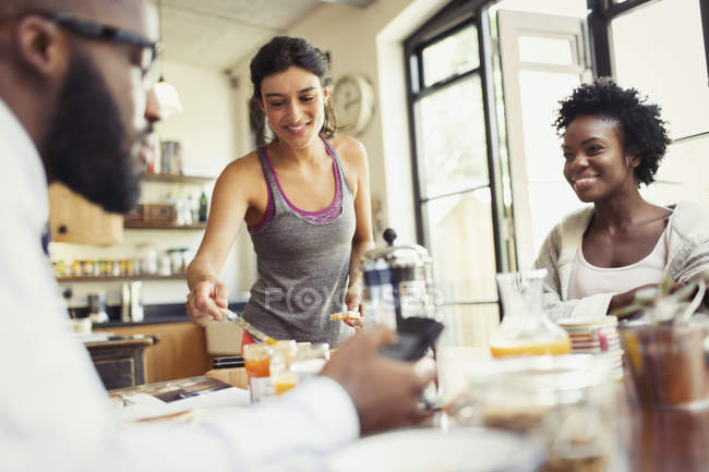 Compañeros de cuarto amigos desayunando en la cocina - foto de stock