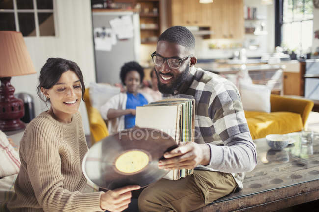Paar schaut sich Schallplatten im Wohnzimmer an — Stockfoto