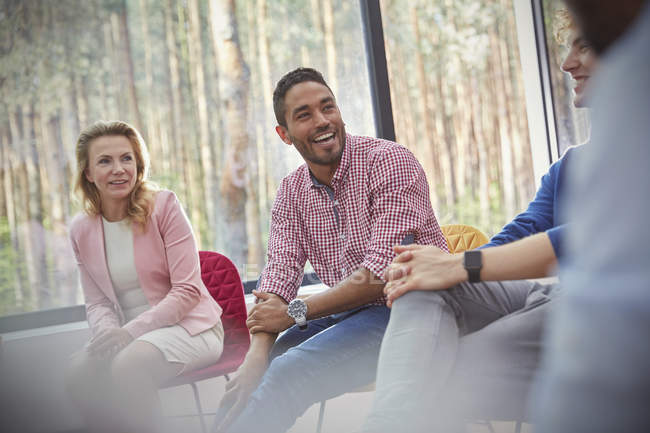 Smiling man listening in group therapy session — Stock Photo