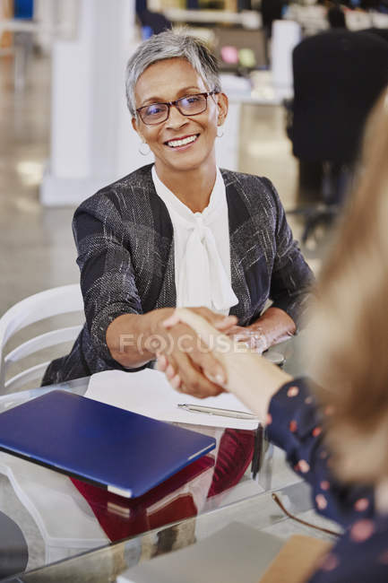 Businesswomen handshaking in meeting at modern office — Stock Photo