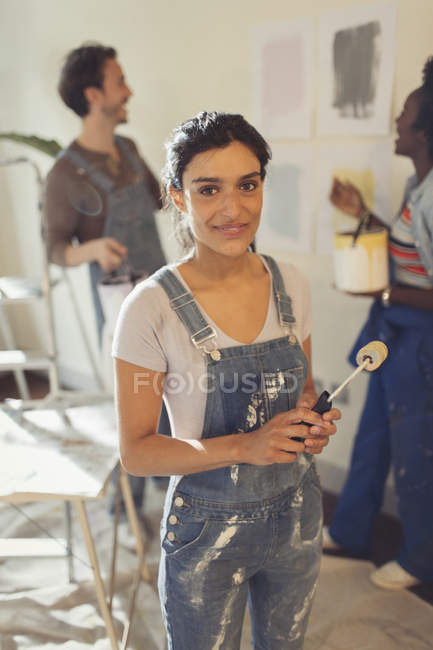 Portrait confident woman painting in living room — Stock Photo
