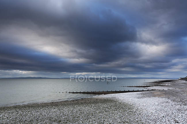 Snow on stormy, remote ocean beach, Silloth, Cumbria, UK — Stock Photo