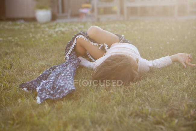 Serene girl laying in summer grass — Stock Photo