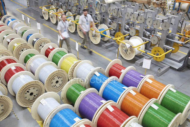 Elevated view multicolor spools in fiber optics factory — Stock Photo