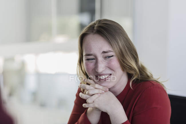 Businesswoman laughing with hands clasped, closeup view — Stock Photo