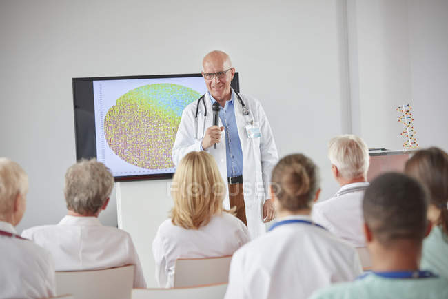 Male surgeon with microphone leading conference — Stock Photo