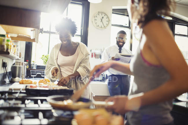 Friend roommates cooking breakfast in kitchen — Stock Photo