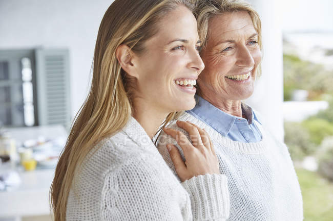 Glückliche Mutter und Tochter schauen auf der Terrasse weg — Stockfoto