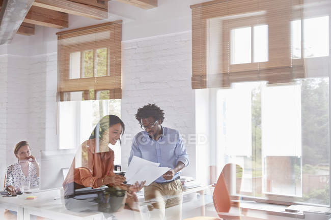 Business people discussing paperwork at modern office — Stock Photo