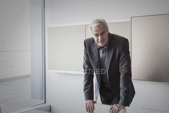Portrait confident senior businessman in conference room — Stock Photo