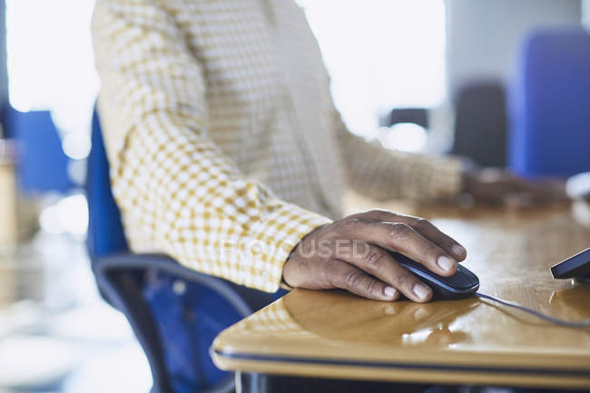 Cropped image of businessman using computer mouse at desk — Stock Photo