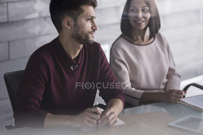 Businessman and businesswoman talking in conference room meeting — Stock Photo