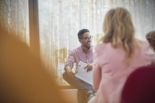 Smiling man talking in group therapy session — Stock Photo