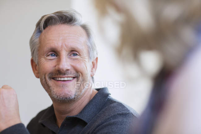 Smiling mature man listening to woman — Stock Photo
