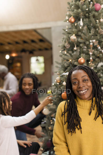 Portrait smiling mother decorating Christmas tree with children — Stock Photo