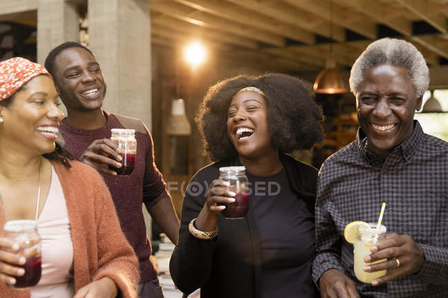 Happy multi-generation family drinking lemonade and sangria — Stock Photo