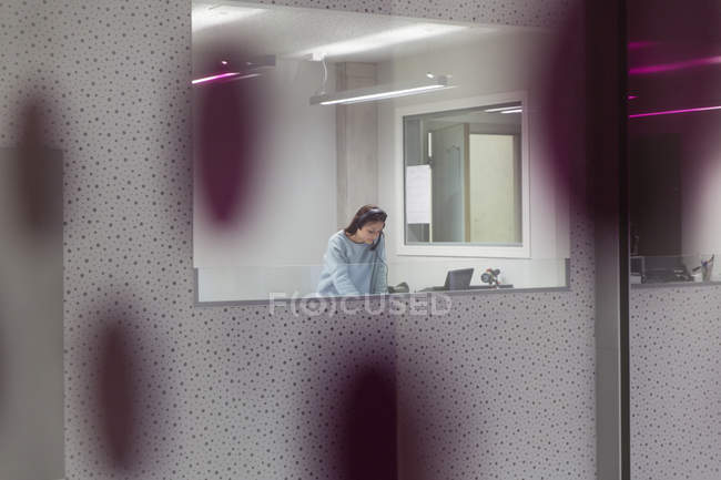 Teenage girl musician recording music in sound booth — Stock Photo