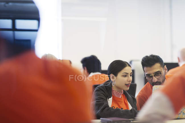 Focused hackers coding for charity at hackathon — Stock Photo