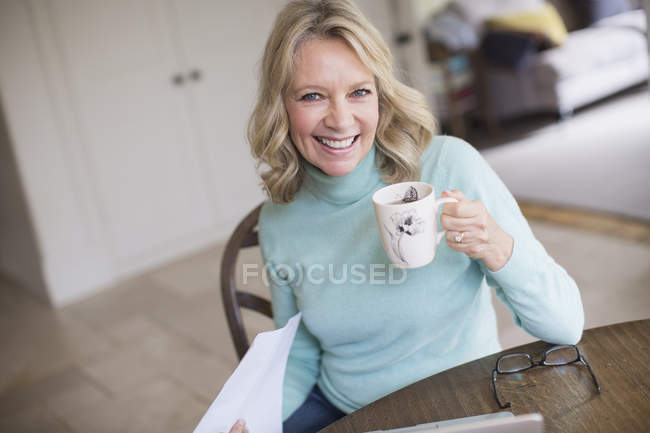 Portrait smiling, confident mature woman drinking tea — Stock Photo
