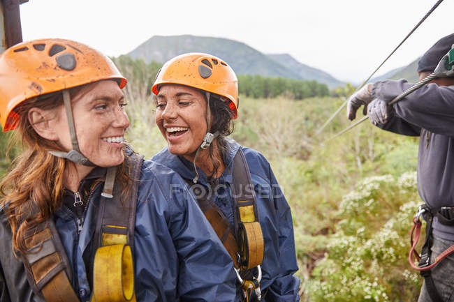 Happy women friends zip lining — Stock Photo