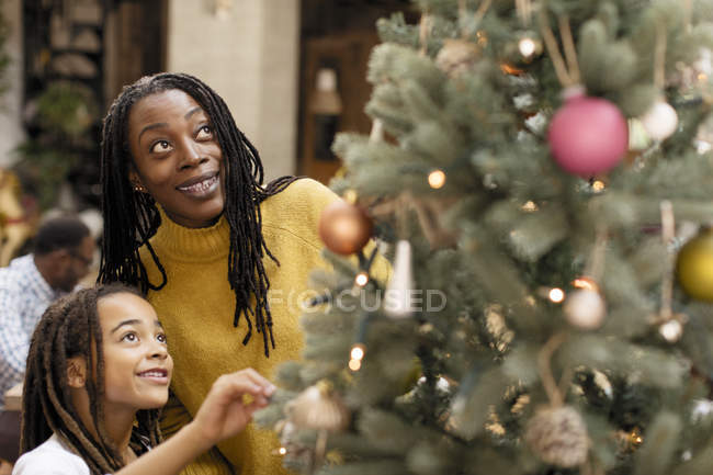 Mother and daughter decorating Christmas tree — Stock Photo