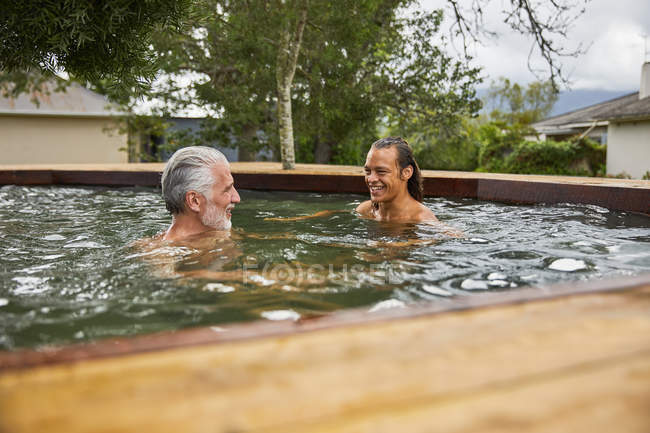 Father and son relaxing in hot tub — Stock Photo