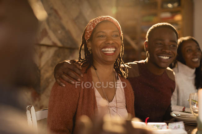 Portrait enthusiastic mother and son enjoying Christmas dinner with family — Stock Photo
