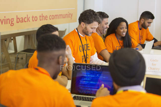 Hackers coding for charity at hackathon — Stock Photo