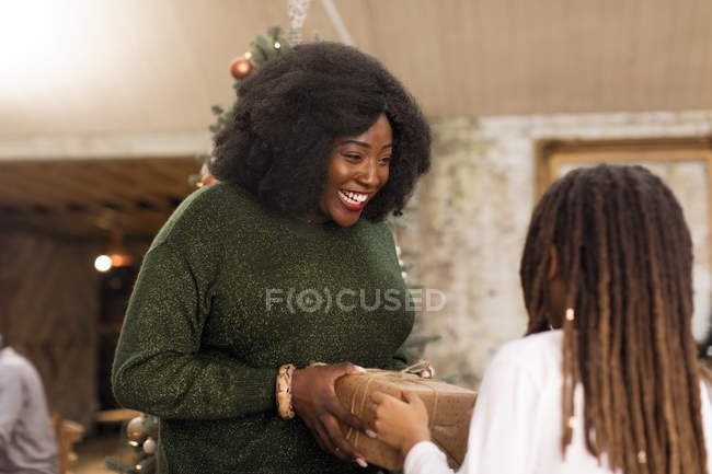 Mother giving Christmas gift to daughter — Stock Photo