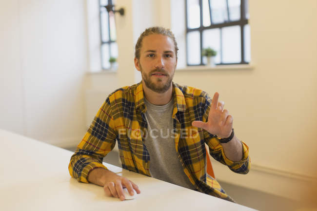 Portrait creative businessman using computer in office — Stock Photo