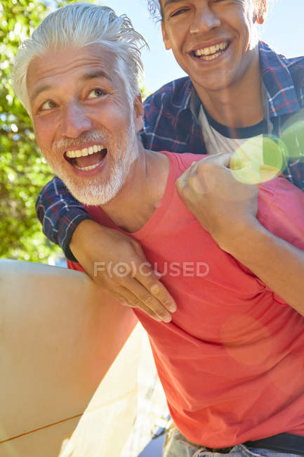 Playful father and son piggybacking — Stock Photo