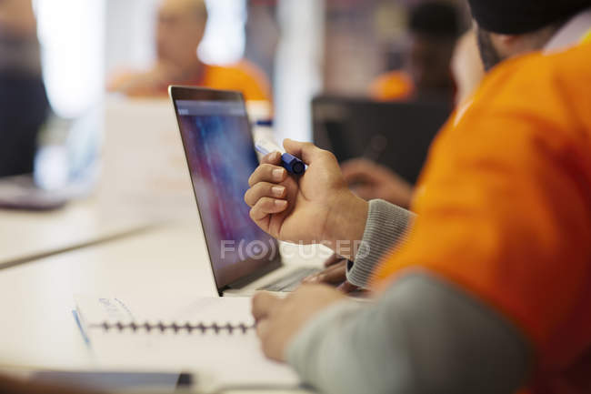 Hacker at laptop coding for charity at hackathon — Stock Photo