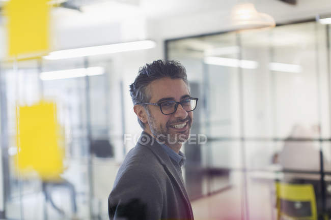 Portrait smiling, confident creative businessman in office — Stock Photo