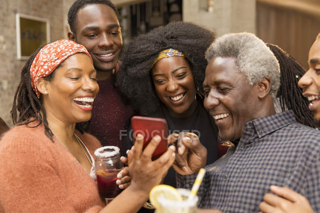 Happy multi-generation family using smart phone — Stock Photo