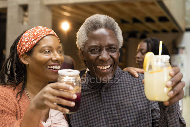 Happy senior father and daughter drinking lemonade and sangria — Stock Photo
