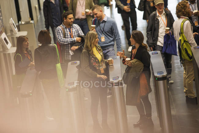 Business people arriving and entering turnstiles at conference — Stock Photo