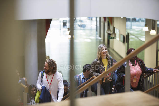 Business people ascending stairs at modern office — Stock Photo