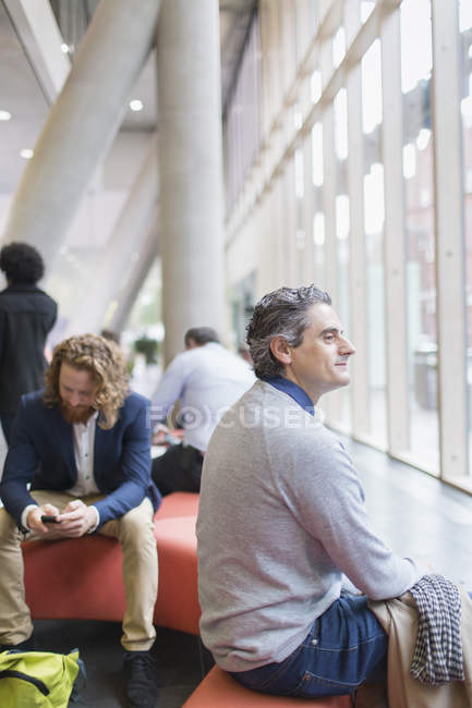 Confident businessman at conference at modern office — Stock Photo