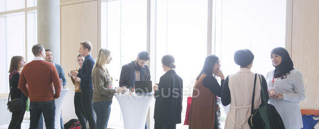 Business people networking, talking at conference — Stock Photo