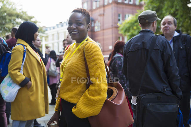 Portrait smiling, confident businesswoman in crowd — Stock Photo