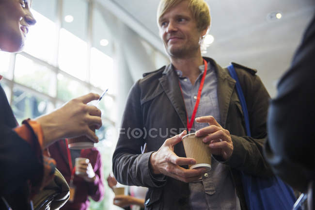 Business people with coffee networking, talking at conference — Stock Photo