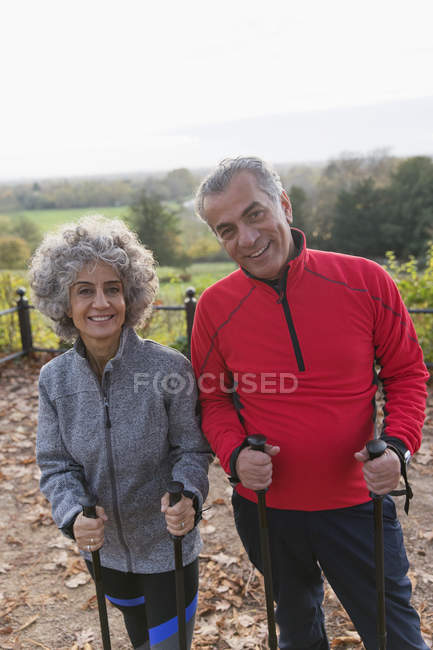 Portrait smiling, confident active senior hikers with poles — Stock Photo