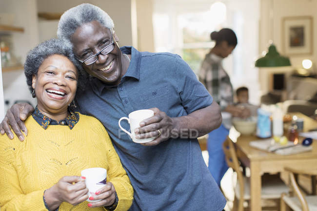 Portrait smiling, affectionate senior couple drinking coffee — Stock Photo