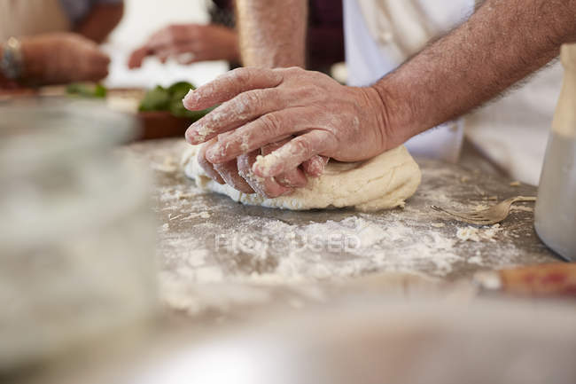 Close up man kneading pizza dough — Stock Photo